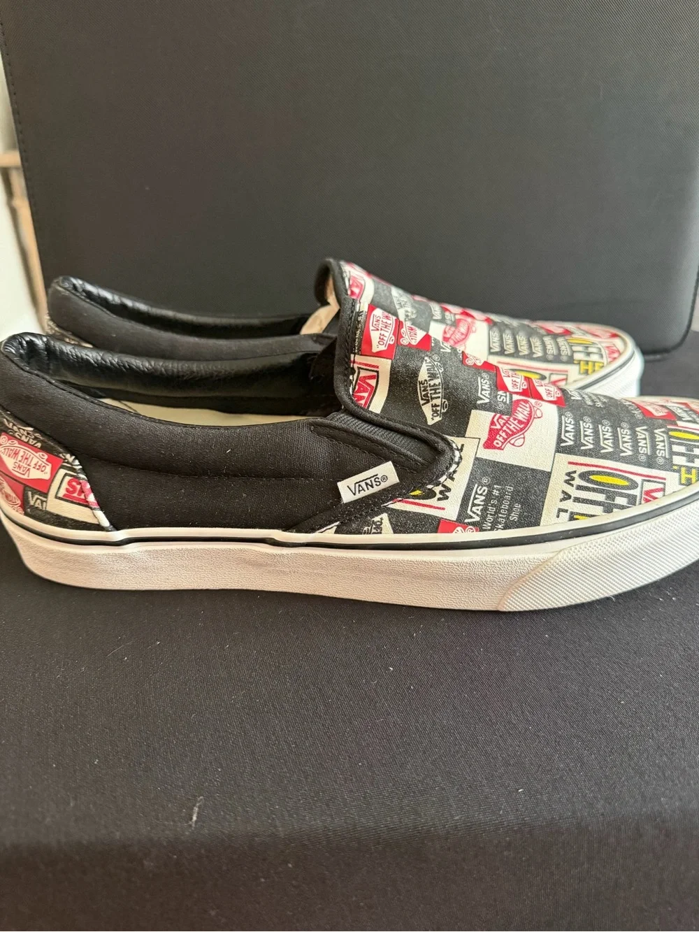 Vans Slip-On Sneakers in Black, White & Red Logo Print